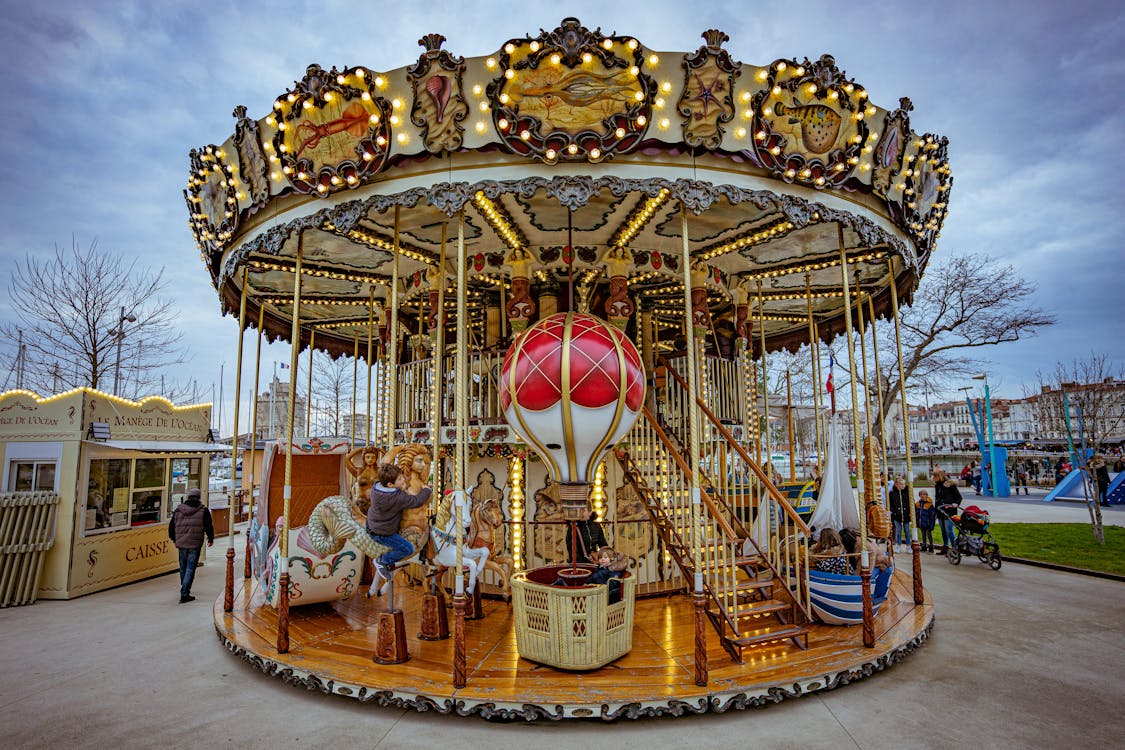 Free Children on a Carousel on a Christmas Market  Stock Photo