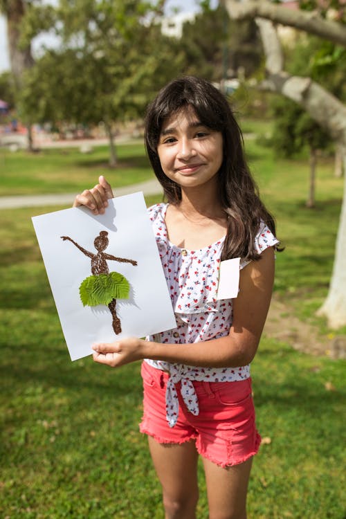 Free Young Girl Showing her Artwork Stock Photo