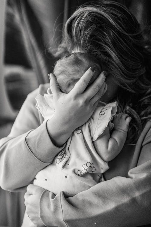 Free Tender moment captured between mother and baby, displaying love and warmth. Stock Photo