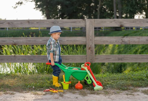 Free Boy with Toy Wheelbarrow Stock Photo