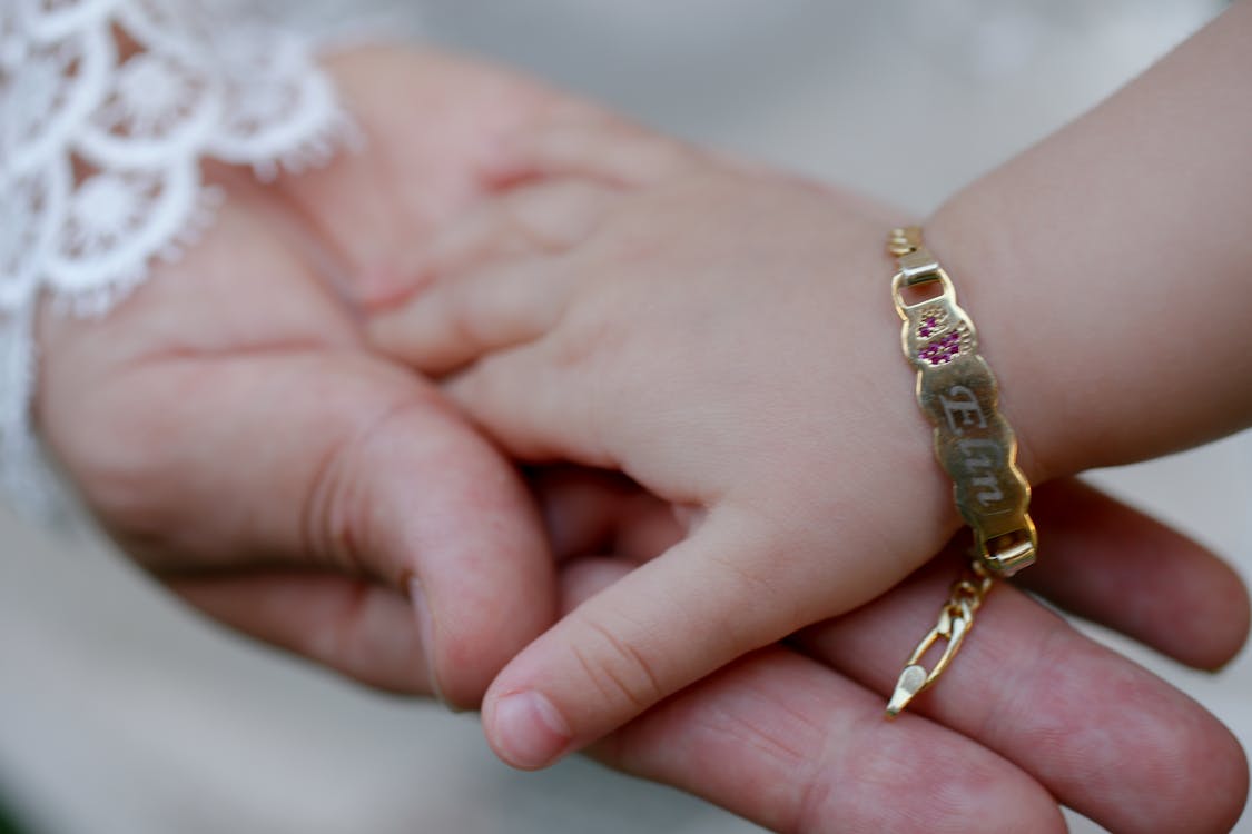 Free A Mother's Hand Holding her Daughter's Hand Stock Photo