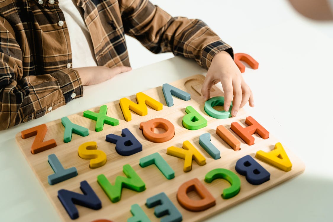 Free 
A Child Playing with an Alphabet Toy Stock Photo