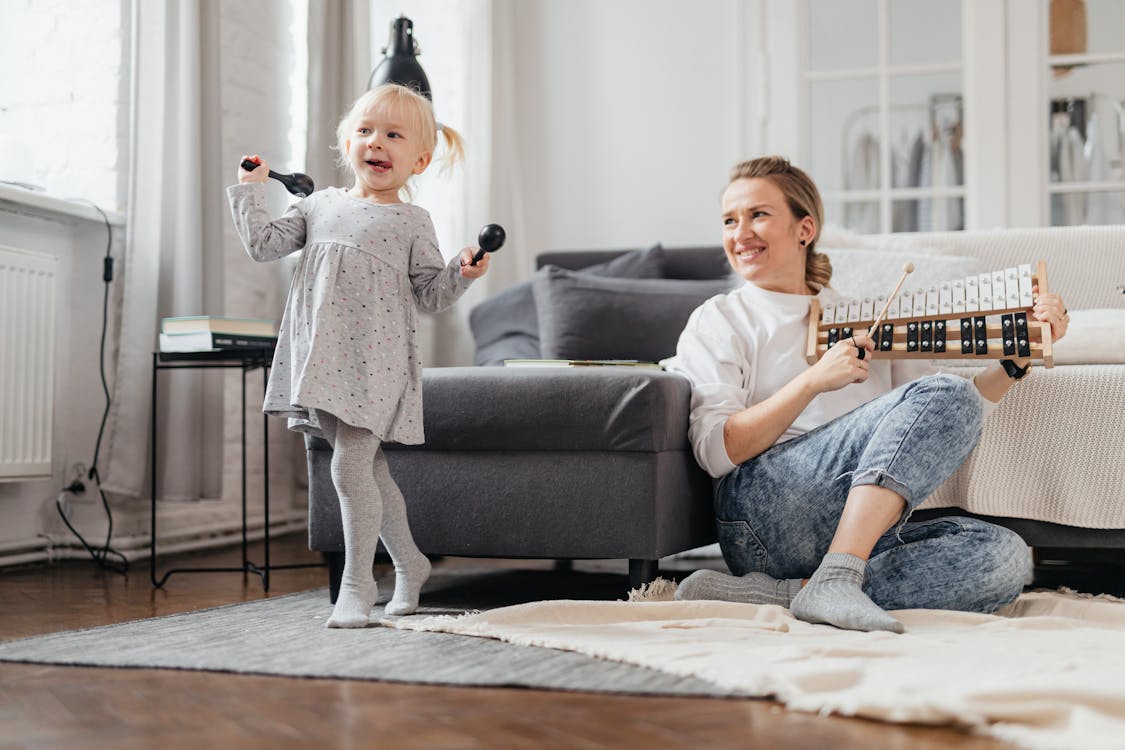 Free A Young Girl Dancing While Holding Maracas Stock Photo