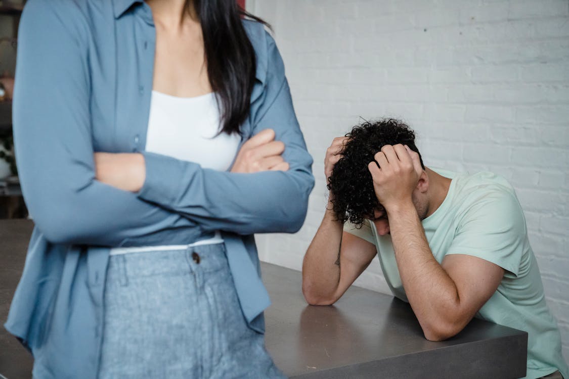 Free A couple experiencing relationship stress and conflict in an indoor setting, illustrating discord and tension. Stock Photo